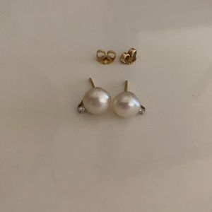 Pearl with diamond accent earrings on 14k yellow gold.